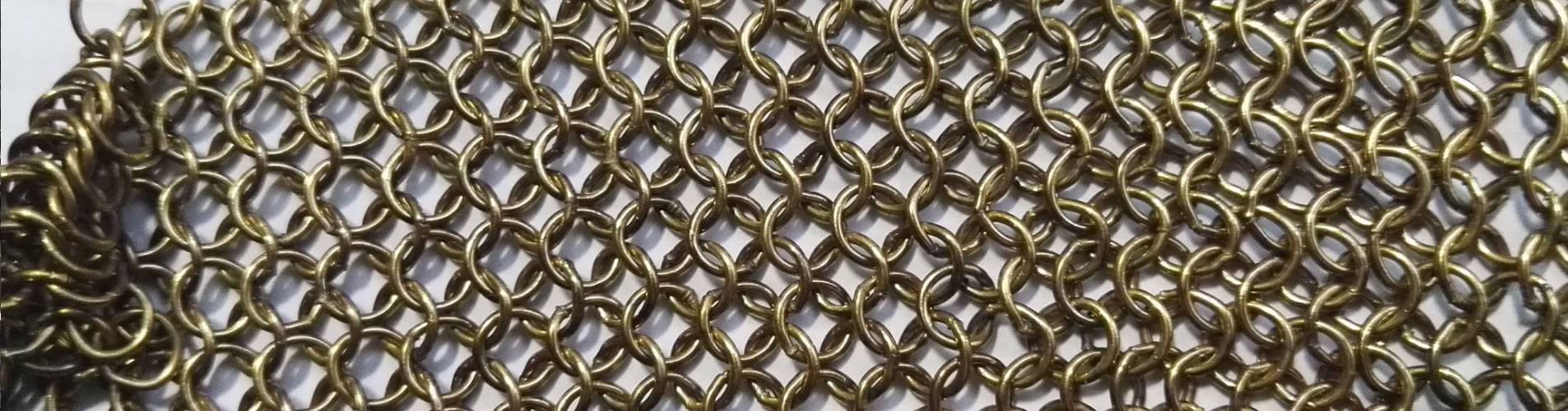 A piece of brass welded round chainmail.