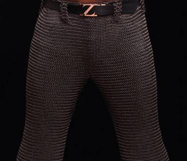 A person is wearing a pair of dark brown chainmail chausses with a black belt.